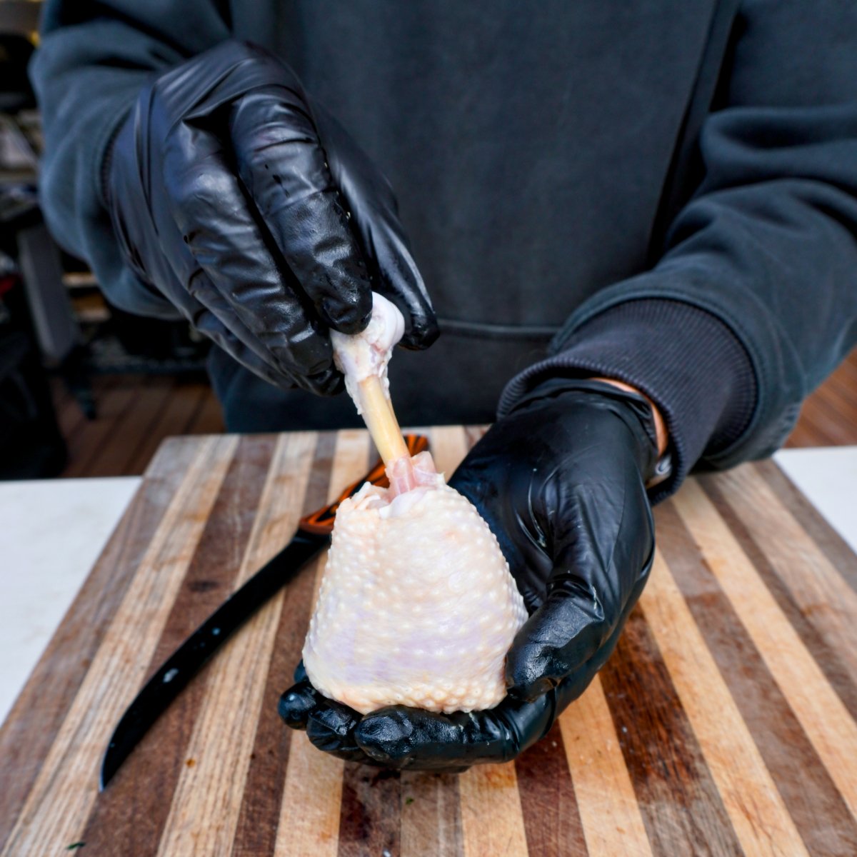 prepared, raw chicken drumstick made into a lollipop. 