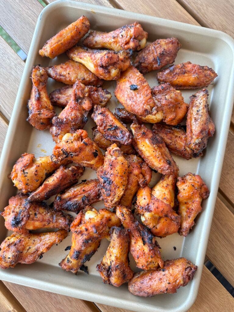 grilled wings on a metal tray. 