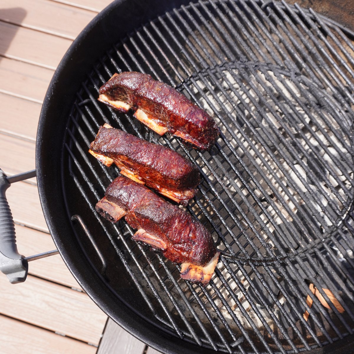 grilled beef short rib bites on the grates.