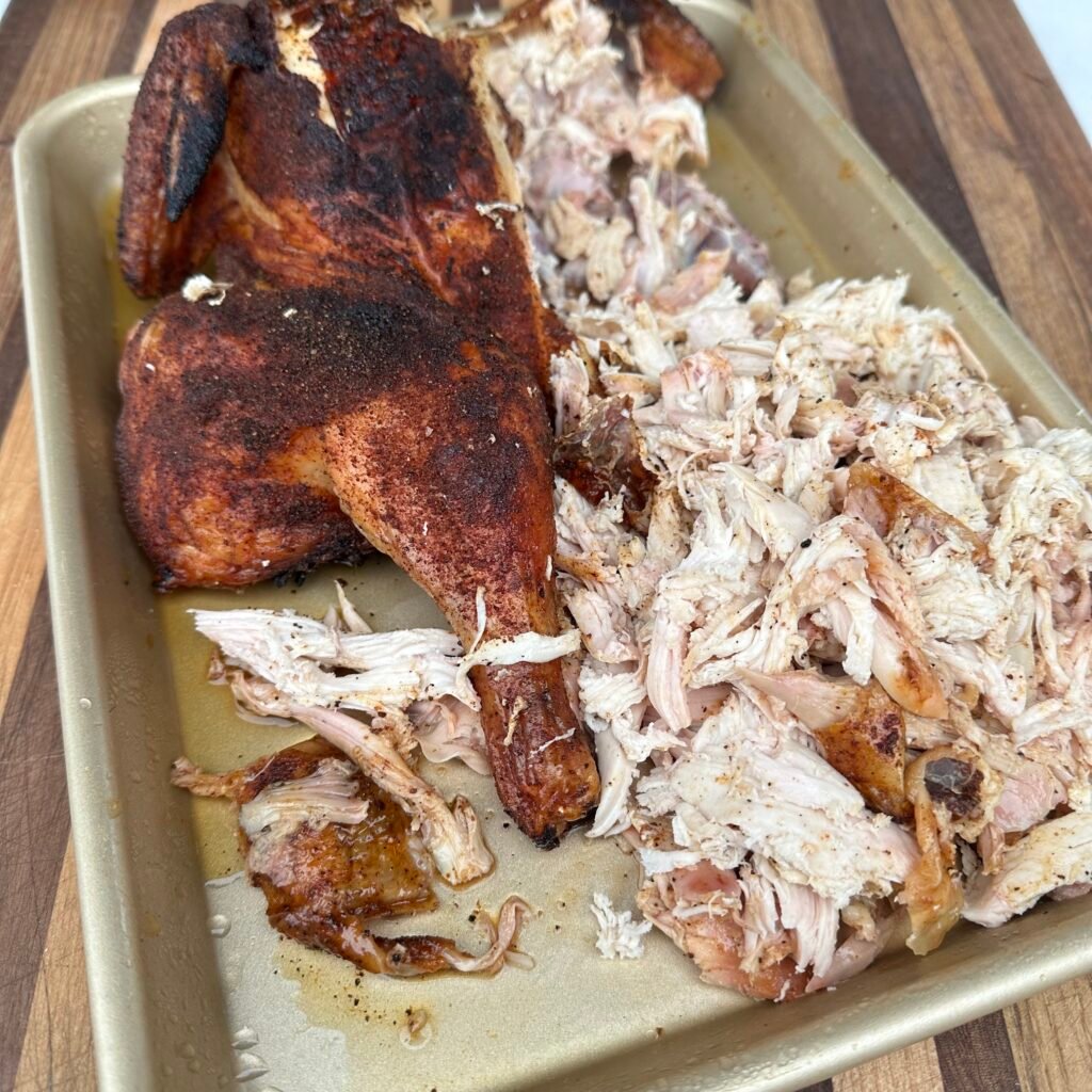 shredded chicken on a cutting board. 
